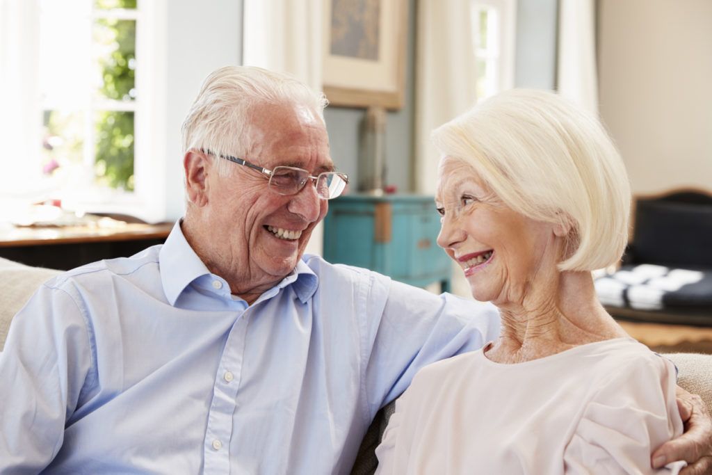 ett äldre par som tittar på varandra och ler